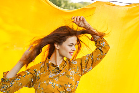 woman in yellow dress posing hairstyle funの写真素材