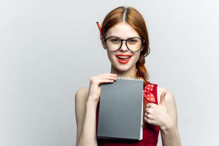 Business woman in red dress notebook pencil professionalsの写真素材