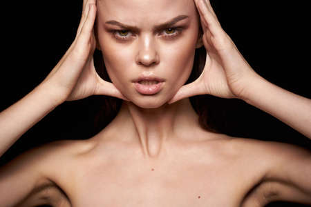 portrait of a woman emotions gesture hands bare shoulders close-upの写真素材