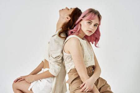 two girlfriends standing side by side posing fashion luxuryの写真素材