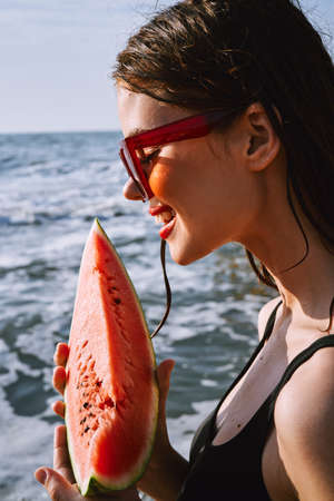 woman eating watermelon outdoors Sun summer close-upの写真素材
