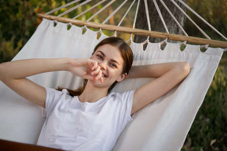 woman working on laptop in nature hammock freelanceの写真素材