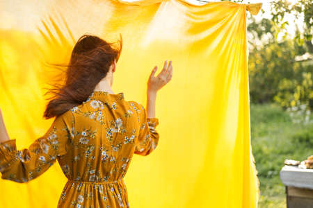 woman in dress posing nature yellow cloth fresh airの写真素材