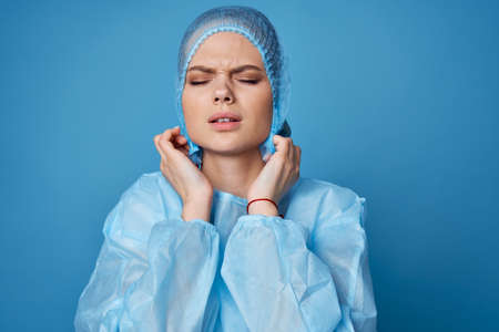 doctor in protective clothing treatment hospital blue backgroundの写真素材