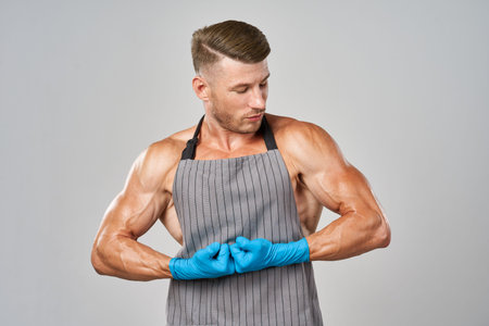 sports man in rubber gloves apron cleaning service