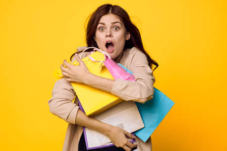 glamorous woman shopping entertainment lifestyle yellow backgroundの写真素材