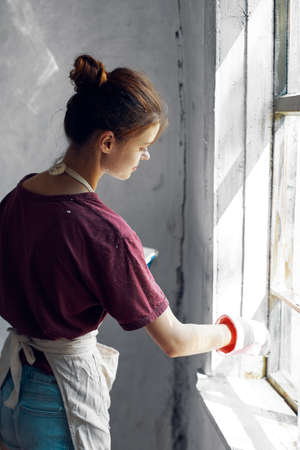 woman paints the window in the room interior renovation decorationの写真素材