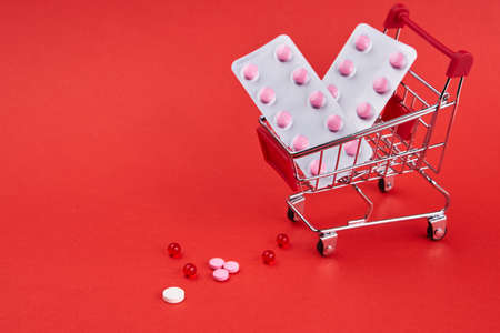 small trolley with medicines pharmacy shop pills shoppingの写真素材