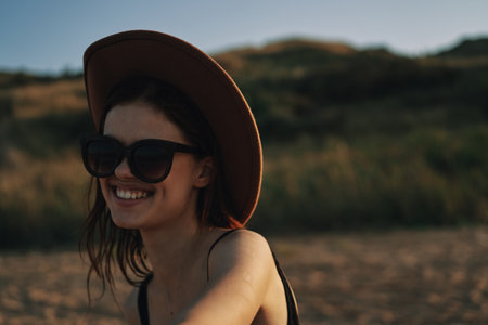 woman in sunglasses near car travel summer vacation landscapeの写真素材