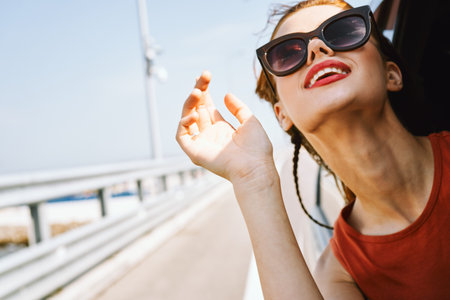 cheerful woman peeking out of the car window trip adventure lifestyle