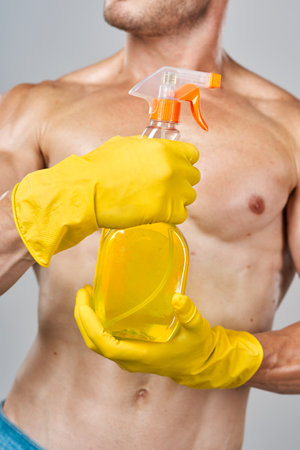 funny pumped up man rubber gloves detergents serviceの写真素材