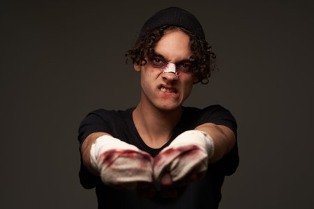 a fighter with a broken nose aggression conflict the dark background
