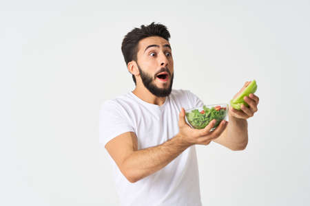 man in white t-shirt plate salad healthy food dietの写真素材