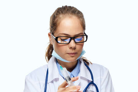female laboratory assistant in white coat chemical solution analyzes researchの写真素材