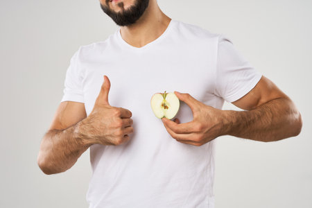 emotional bearded man with apple in his hands fruit snack