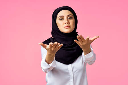 muslim woman with calculator and finance money pink backgroundの写真素材