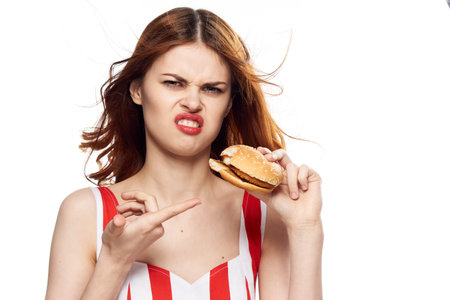 woman with fast food diet food snack light background