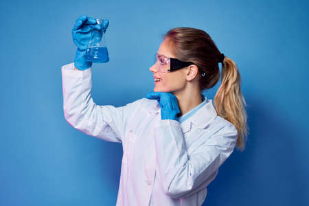 female doctor in white coat hospital treatment blue backgroundの写真素材