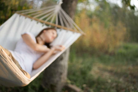 woman sleeping in hammock outdoors leisure lifestyleの写真素材