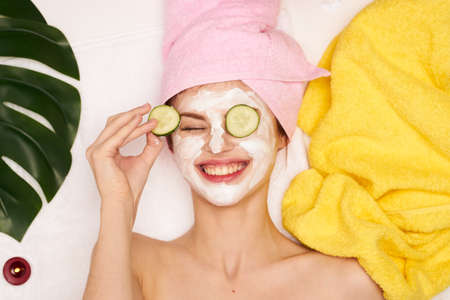 pretty woman with a towel on my head skin care view from aboveの写真素材