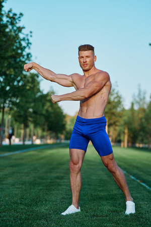 man doing exercises in the park inflated body