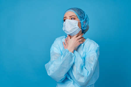doctor in protective clothing treatment hospital blue backgroundの写真素材