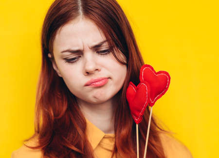 pretty woman heart on a stick emotions holiday yellow backgroundの写真素材