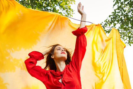 woman in red dress outdoors yellow bedspread