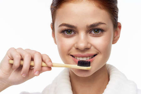 Woman in white coat toothbrush oral hygieneの写真素材