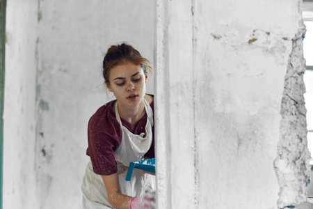 woman painter In white apron home renovation interiorの写真素材