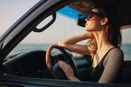 woman driving in car trip posing fashion travelの写真素材