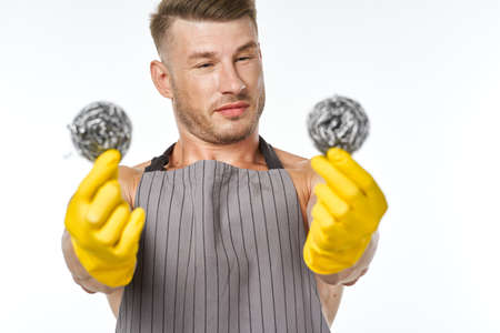 pumped up man in rubber gloves metal sponges close-upの写真素材