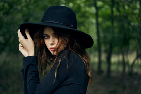 woman in black dress in the forest Halloween Witch costume