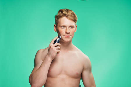 guy cleans skin care shaving posing naked torsoの写真素材