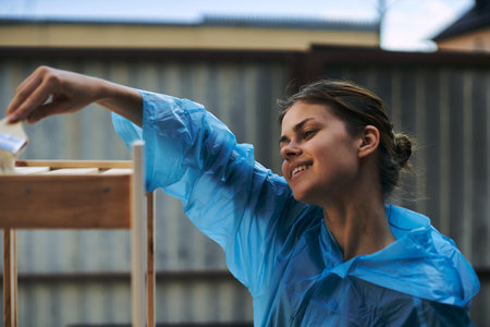 woman painter painting wood home renovation textureの写真素材