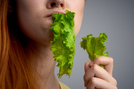 woman with lettuce leaf healthy food diet lifestyleの写真素材