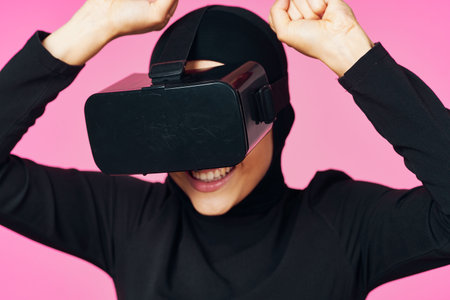 muslim woman wearing virtual reality glasses entertainment technology deviceの写真素材