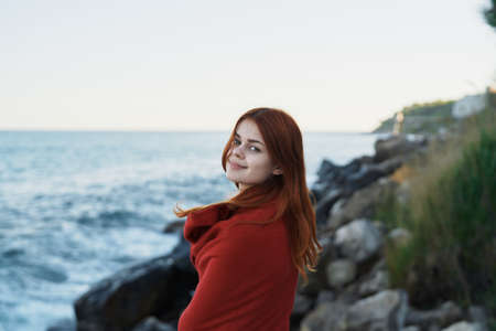 woman hiding with a blanket in nature with a camera vacation photographer travelの写真素材