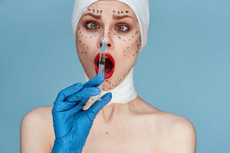 woman Red lips plastic surgery operation bare shoulders studio lifestyleの写真素材
