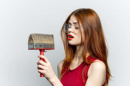 cheerful woman with paint brush housework interior renovationの写真素材