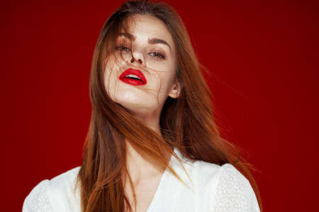 pretty woman fashion hairstyle posing red lips isolated backgroundの写真素材