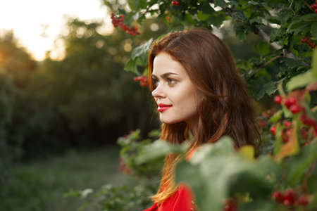 pretty woman in red dress glamor posing nature