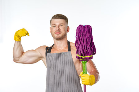 sporty man in aprons with a mop cleaning service