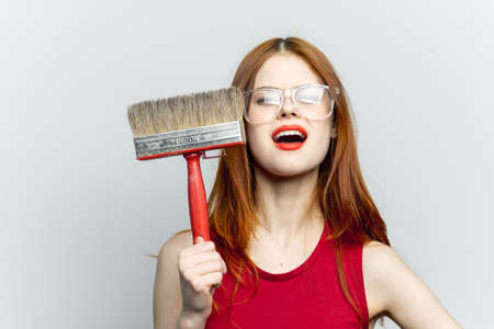 cheerful woman with paint brush housework interior renovationの写真素材