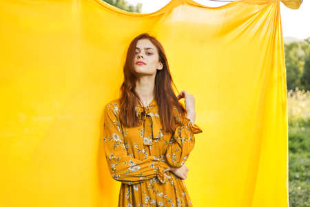pretty woman posing hairstyle nature fashion yellow backgroundの写真素材