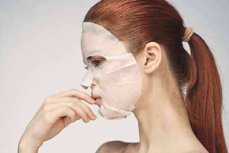 woman in cosmetic mask facial skin care rejuvenationの写真素材