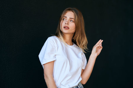 woman in white t-shirt on dark background fun posing fashion