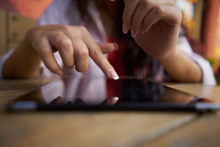 wooden table outdoor cafe tablet work lifestyleの写真素材