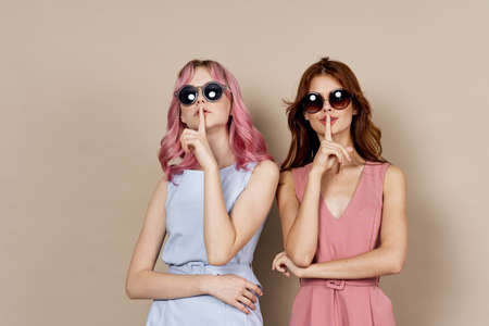 two women fashionable clothes posing accessories summer styleの写真素材
