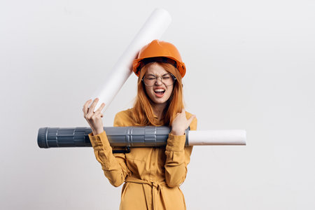 female engineer in orange hard hat blueprints architectの写真素材
